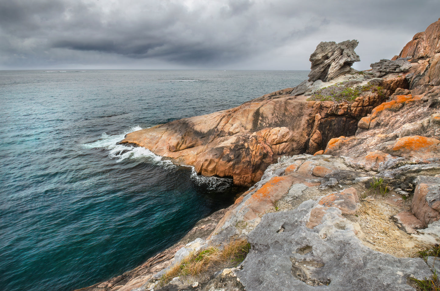 Limestone wedge, broken away and balanced precariously on the granite below.