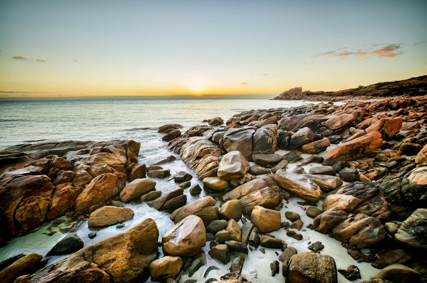 Rocks on a beach at sunset