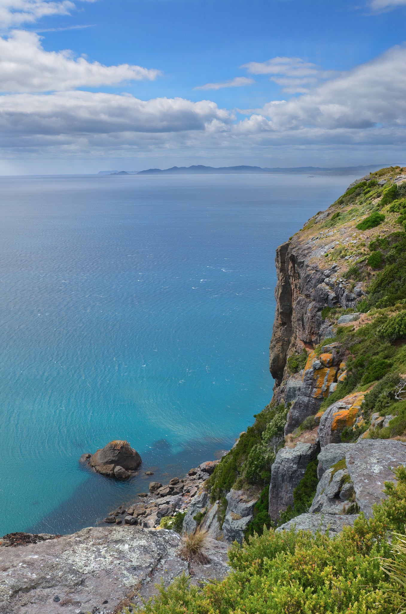 Clifftop view above clear, colourful water in Stanley, Tasmania.