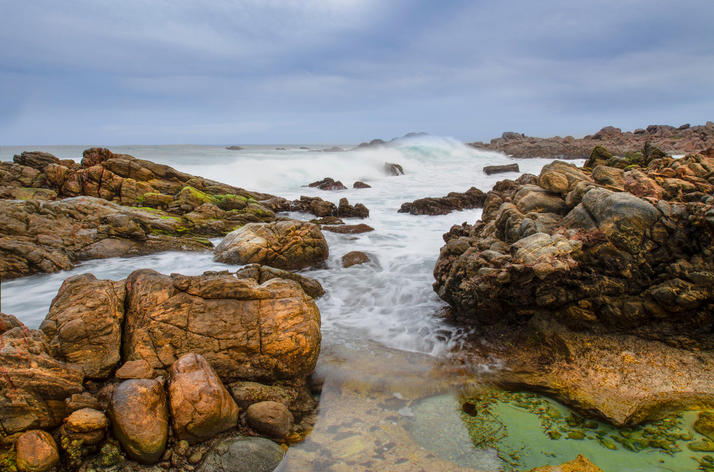 Moody seascape with rolling waves on a rocky section of Cape Naturaliste, Western Australia.