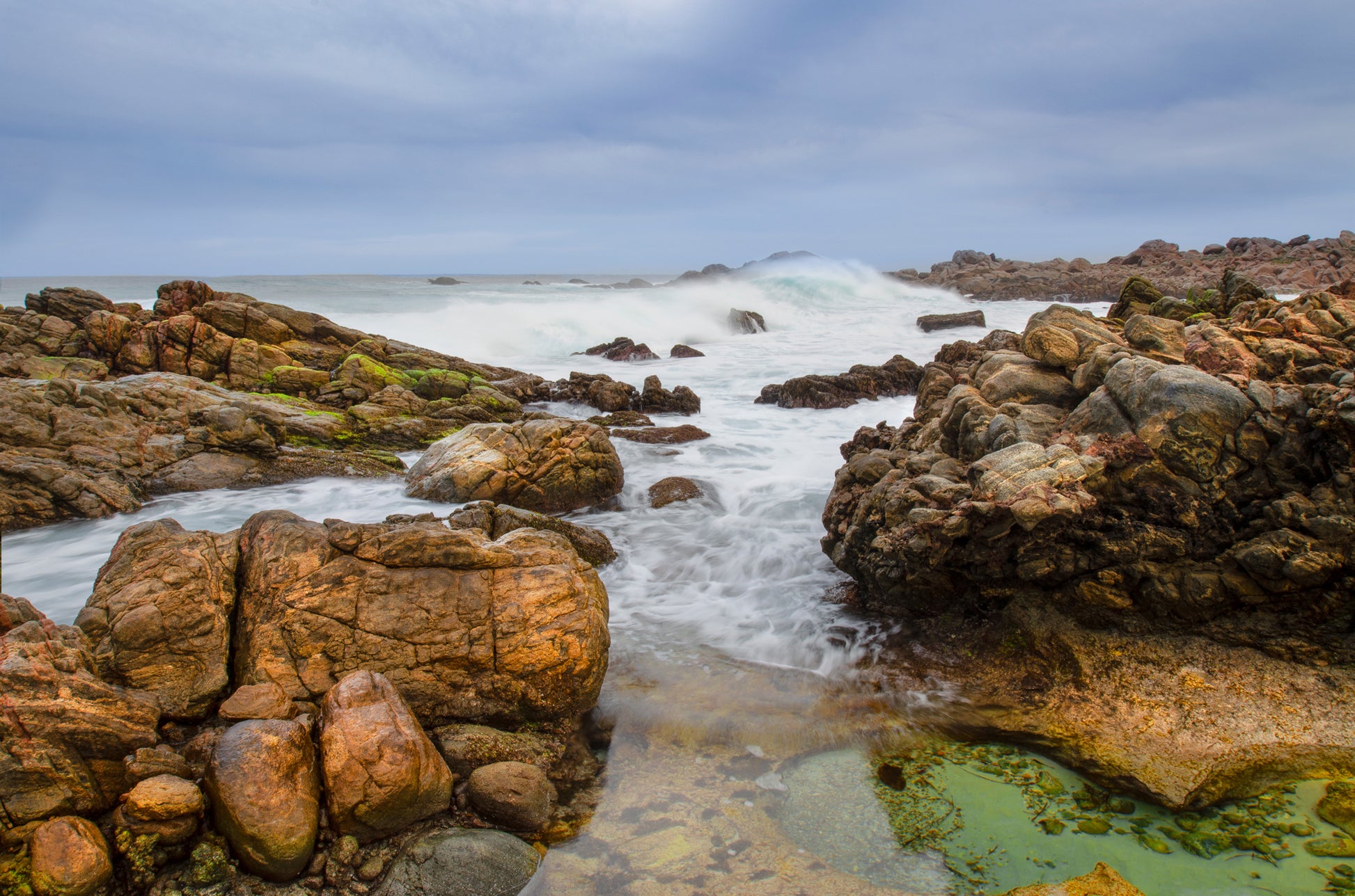 Moody seascape with rolling waves on a rocky section of Cape Naturaliste, Western Australia.