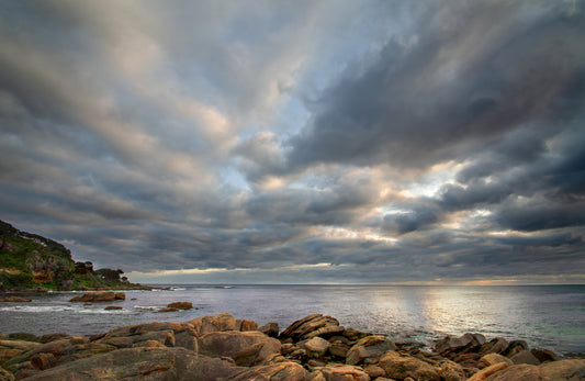 Early morning light revealing a dramatic, moody sky.