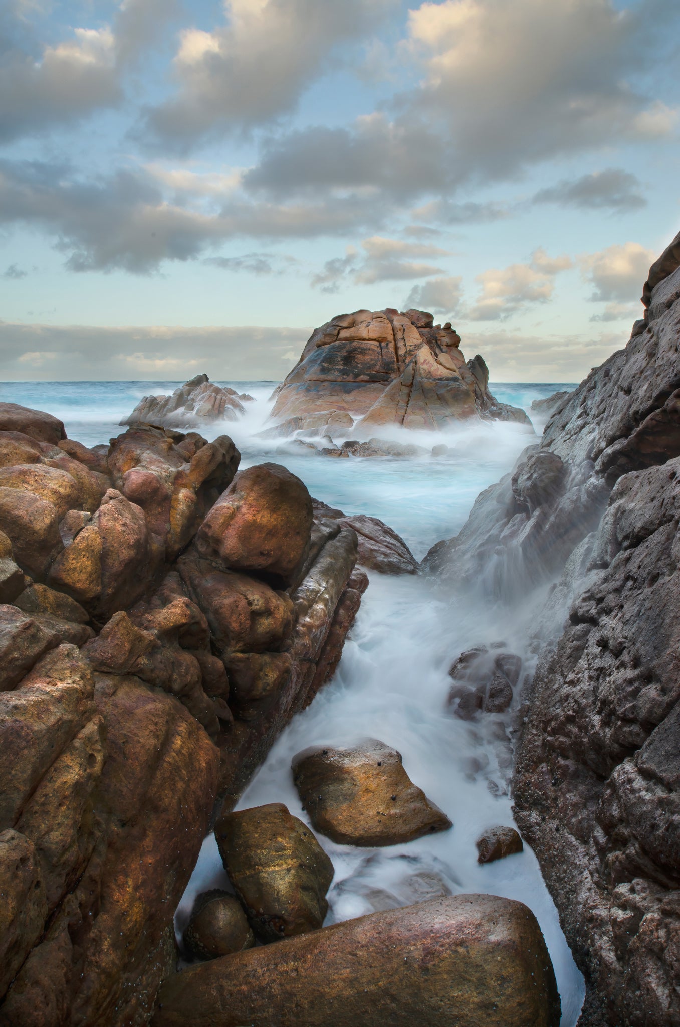 Weathered granite combined with frozen movement against a changing sky.