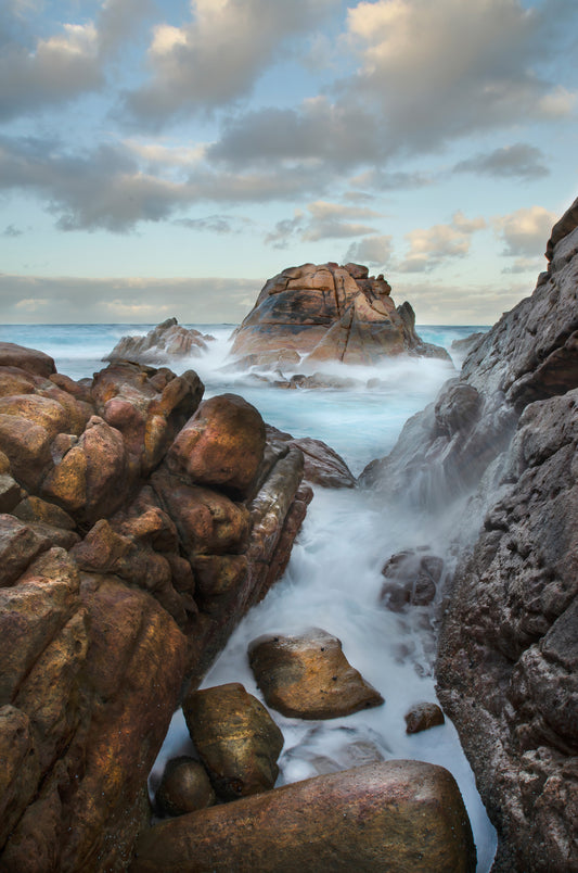 Weathered granite combined with frozen movement against a changing sky.