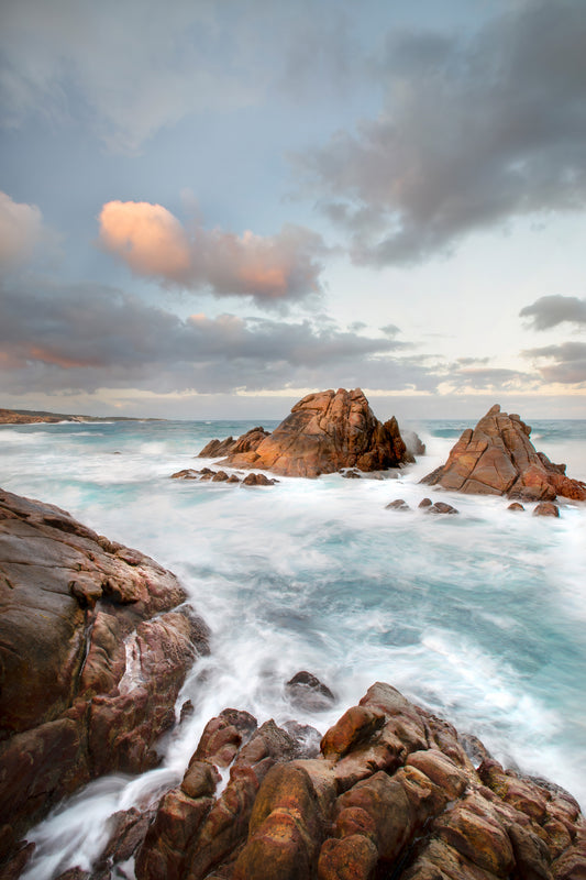 Rugged Canal Rocks coastline with ocean surges under a dramatic sky.