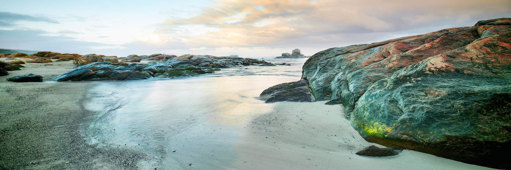 Dawn at Redgate Beach with reflective water.