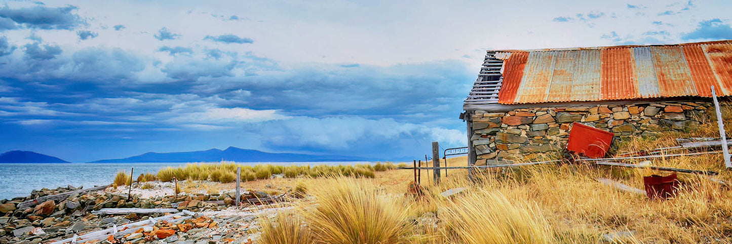 Old boat shed on the shores of a lake in Tasmania.
