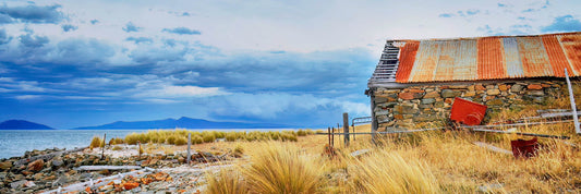 Old boat shed on the shores of a lake in Tasmania.