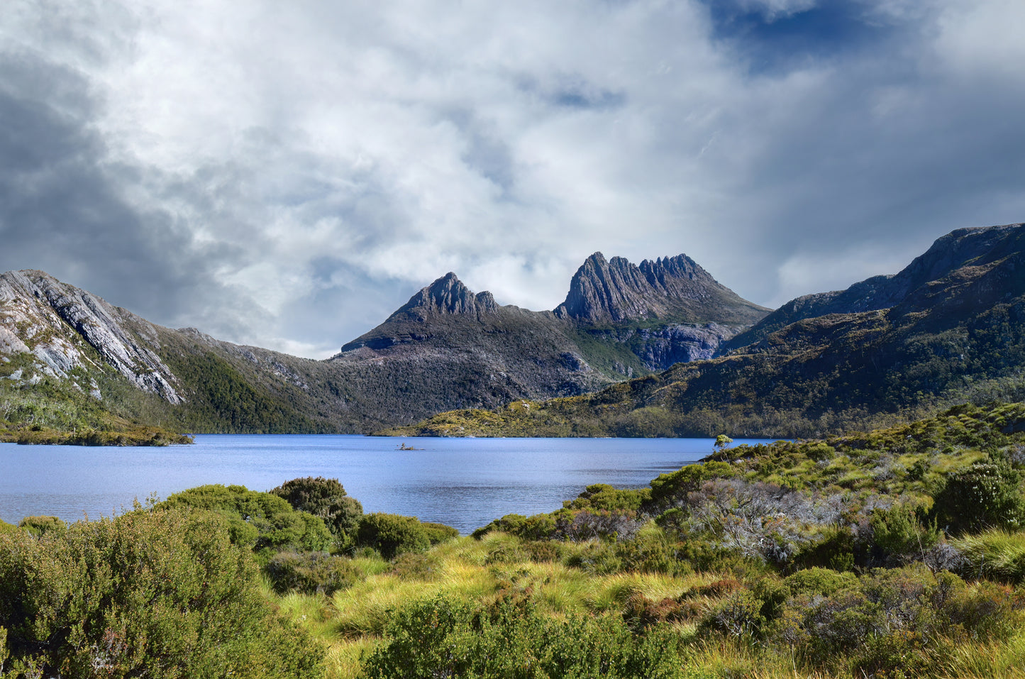 Wide-angle landscape of Cradle Mountain and Dove Lake under a stormy sky.